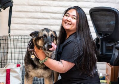 Vet staff hugging dog